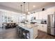 This kitchen island has white cabinets, granite countertops and overlooks the dining area with modern pendant lighting at 1534 Cloverdon Dr, Westfield, IN 46074