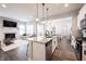 The gourmet kitchen island offers seating and overlooks the cozy living room with fireplace, next to a dining area at 1534 Cloverdon Dr, Westfield, IN 46074