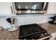 Close-up of a stainless steel gas cooktop and microwave set against white herringbone backsplash and granite countertops at 1534 Cloverdon Dr, Westfield, IN 46074