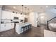 A modern kitchen with white cabinets, stainless steel appliances, granite counters, and a central island with barstool seating at 1534 Cloverdon Dr, Westfield, IN 46074