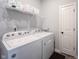 Laundry room equipped with modern washer and dryer, complemented by functional shelving and neutral tones at 1534 Cloverdon Dr, Westfield, IN 46074