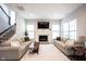 Spacious living room with a fireplace, hardwood floors, and a staircase at 1534 Cloverdon Dr, Westfield, IN 46074