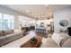 Open-concept living space boasts a seamlessly connected living, dining, and kitchen area with modern decor and lighting at 1534 Cloverdon Dr, Westfield, IN 46074