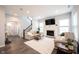 Open-concept living room with natural light, a fireplace, and hardwood floors at 1534 Cloverdon Dr, Westfield, IN 46074