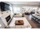 Open-concept space with fireplace, living room, dining area, and modern kitchen with island seating at 1534 Cloverdon Dr, Westfield, IN 46074