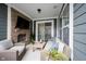 Covered patio featuring a brick fireplace with a mounted TV and comfortable seating for relaxation at 1534 Cloverdon Dr, Westfield, IN 46074