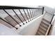 Carpeted staircase with white risers, black metal railing leading to the next level at 1534 Cloverdon Dr, Westfield, IN 46074
