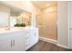 Bathroom featuring a double vanity, a large mirror, and a glass-enclosed shower at 1571 Beyers St, Fortville, IN 46040