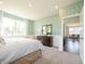 A light filled bedroom with wall to wall carpeting, an accent wall and view to the dining room at 1571 Beyers St, Fortville, IN 46040