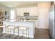 Spacious kitchen with white cabinets, stainless steel appliances, and a large island with seating at 1571 Beyers St, Fortville, IN 46040