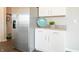 Close-up of a kitchen area showing modern stainless steel refrigerator and white cabinets at 1571 Beyers St, Fortville, IN 46040