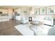 Open-concept living area with a white sofa, round coffee table, and seamless flow to the kitchen at 1571 Beyers St, Fortville, IN 46040