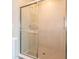 Modern shower with glass door and tan tiled walls and base at 1571 Beyers St, Fortville, IN 46040