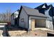 New gray home with unfinished garage with modern farmhouse design details at 16375 Burlwood Dr, Westfield, IN 46074