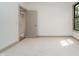 A carpeted bedroom has neutral walls, light colored trim, and a large window at 1818 Central Ave, Indianapolis, IN 46202