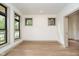 Bright bedroom featuring hardwood floors, black frame windows, and neutral wall paint at 1818 Central Ave, Indianapolis, IN 46202