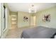 Bright bedroom featuring wood flooring, modern light fixture, closet, and ensuite bathroom at 1818 Central Ave, Indianapolis, IN 46202