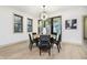 Dining room with statement lighting, black framed windows, and slider door to the outdoors at 1818 Central Ave, Indianapolis, IN 46202