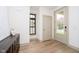 Bright entry featuring hardwood floors and a stylish front door at 1818 Central Ave, Indianapolis, IN 46202