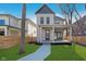 Beautiful two-story home featuring a cozy front porch and green lawn at 1818 Central Ave, Indianapolis, IN 46202