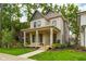 Inviting two-story home with a covered porch and well-manicured lawn at 1818 Central Ave, Indianapolis, IN 46202