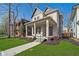 Charming home boasts a welcoming front porch and professionally landscaped yard at 1818 Central Ave, Indianapolis, IN 46202