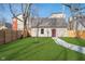 Detached garage with walkway on a lush green lawn in the backyard at 1818 Central Ave, Indianapolis, IN 46202