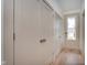 Hallway with utility closets leading to a door with exterior view at 1818 Central Ave, Indianapolis, IN 46202