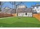 Fenced backyard with a well-maintained lawn and a detached garage at 1822 Central Ave, Indianapolis, IN 46202