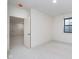 Unfurnished basement bedroom featuring neutral carpet, a window, and a large closet at 1822 Central Ave, Indianapolis, IN 46202