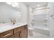 Bathroom features wood cabinets, a white marble countertop, and a shower-tub combo at 1822 Central Ave, Indianapolis, IN 46202