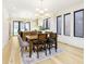 Bright dining room featuring wood floors, large windows, and a modern light fixture at 1822 Central Ave, Indianapolis, IN 46202
