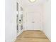 New construction entryway with light hardwood floors and a pair of white doors at 1822 Central Ave, Indianapolis, IN 46202