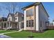 New construction with neutral siding, black trim, modern windows and professionally landscaped yard at 1822 Central Ave, Indianapolis, IN 46202