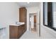 Convenient laundry room with modern cabinetry, a sleek sink, and adjacent access to hallway at 1822 Central Ave, Indianapolis, IN 46202