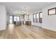 Open concept living area featuring light wood floors, a modern chandelier, and access to the backyard at 1822 Central Ave, Indianapolis, IN 46202