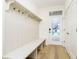 Bright mud room boasts stylish bench seating, hooks, and wood floors at 1822 Central Ave, Indianapolis, IN 46202