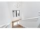 Bright staircase features wood steps, white risers, black frame window, and modern light fixture at 1822 Central Ave, Indianapolis, IN 46202