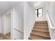 Beautiful staircase featuring wooden steps and sleek white walls and trim at 1822 Central Ave, Indianapolis, IN 46202