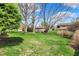 Spacious backyard with mature trees and a well-maintained lawn, providing ample room for outdoor activities at 1829 Catalano Dr, Indianapolis, IN 46214