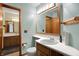 Well-lit bathroom featuring a vanity with a sink, a large mirror, and a connected room at 1829 Catalano Dr, Indianapolis, IN 46214