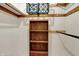 Walk-in closet with wood shelving and hanging rack for storage at 1829 Catalano Dr, Indianapolis, IN 46214