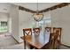 Bright dining area featuring a wood table under a chandelier with large windows at 1829 Catalano Dr, Indianapolis, IN 46214
