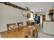 An open dining room with wood table, chandelier, and pass-through to the kitchen area at 1829 Catalano Dr, Indianapolis, IN 46214