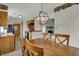 Dining room with wood table leading into an open kitchen and a fireplace in the background at 1829 Catalano Dr, Indianapolis, IN 46214