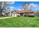 Charming home featuring an attached two-car garage, a neatly manicured green lawn, and mature trees at 1829 Catalano Dr, Indianapolis, IN 46214