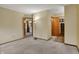 Spacious living room with neutral carpet and views to closet and kitchen at 1829 Catalano Dr, Indianapolis, IN 46214