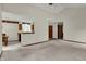 Spacious living area with an open layout, vaulted ceilings, neutral carpet, and access to the kitchen at 1829 Catalano Dr, Indianapolis, IN 46214