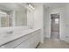Bathroom with double sink vanity, white cabinets, a large mirror, and a tiled shower at 18944 Seaforth Way, Westfield, IN 46074