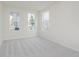 An empty bedroom with three windows and neutral carpet at 18944 Seaforth Way, Westfield, IN 46074